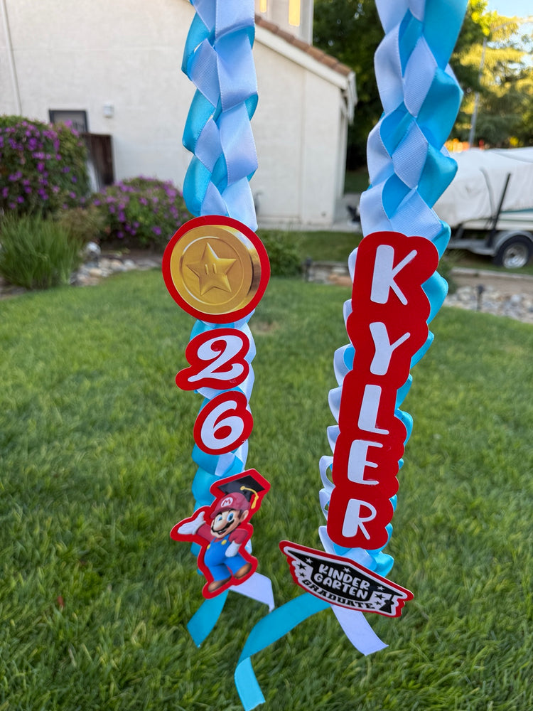 Red and blue personalized graduation ribbon lei with name and 2026 year