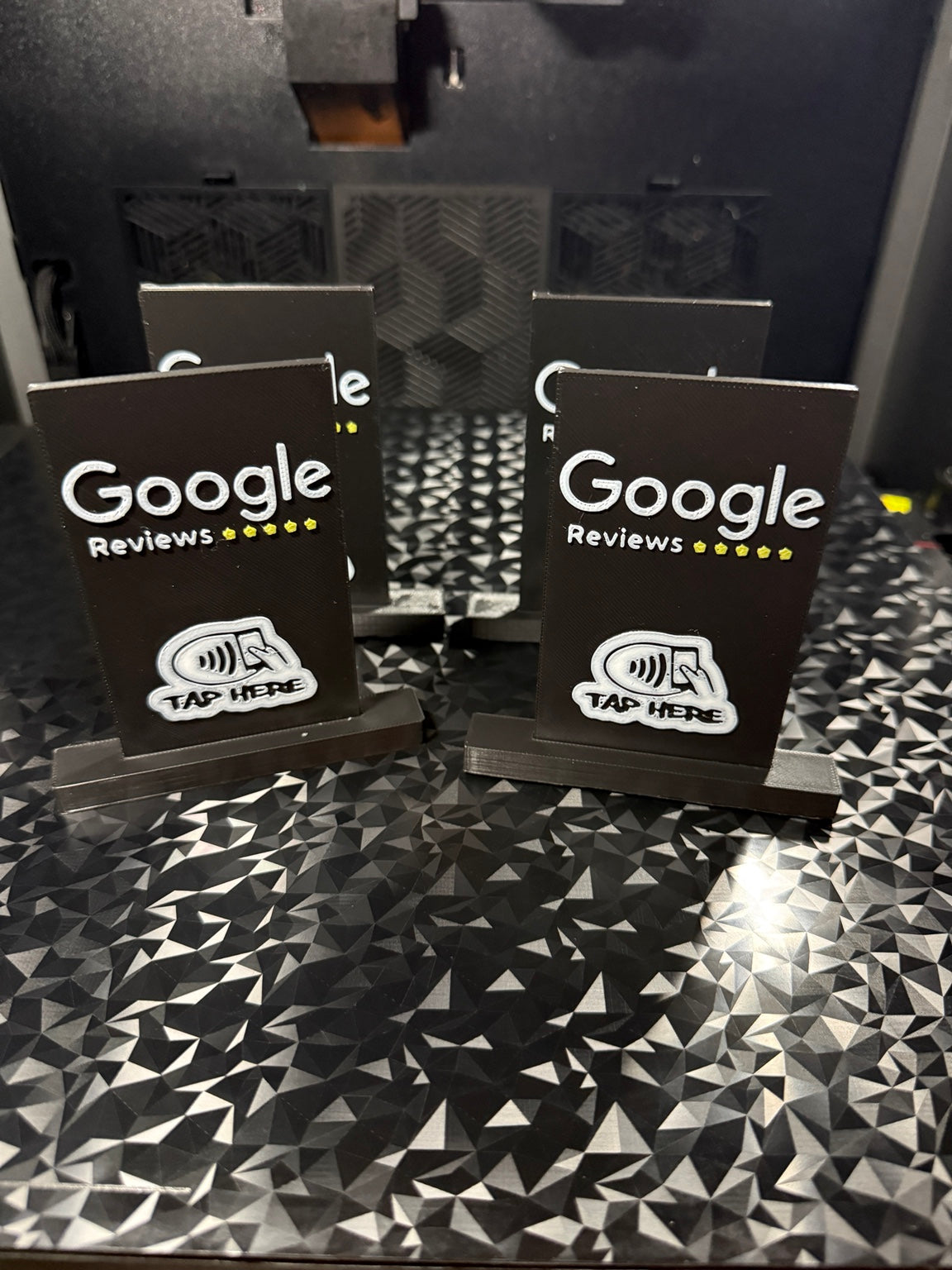 Black 3D printed NFC Google Reviews stand with tap here symbol
