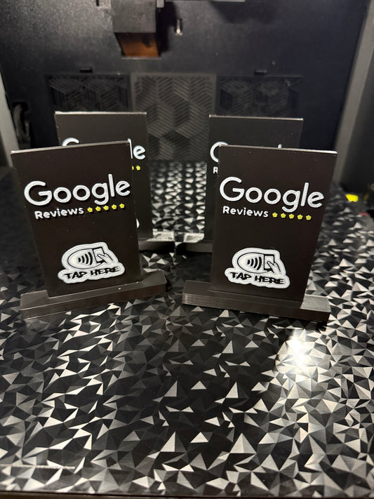 Black 3D printed NFC Google Reviews stand with tap here symbol