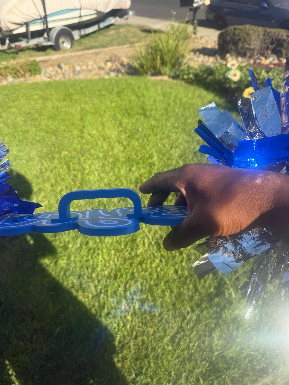 Side view showing the integrated blue hand grip on the custom cheer sign