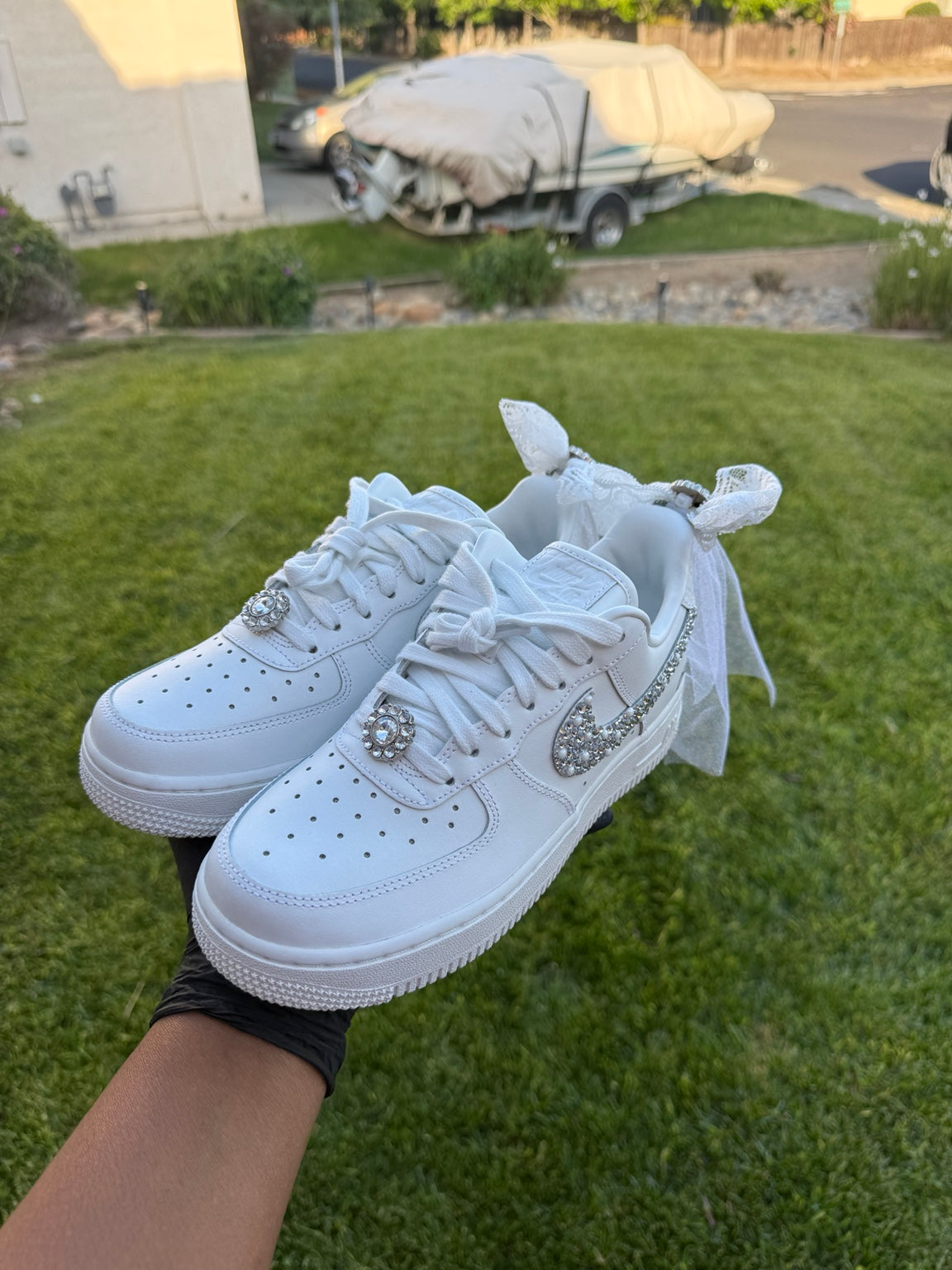 White custom bridal sneakers with rhinestones, pearls, and lace bows