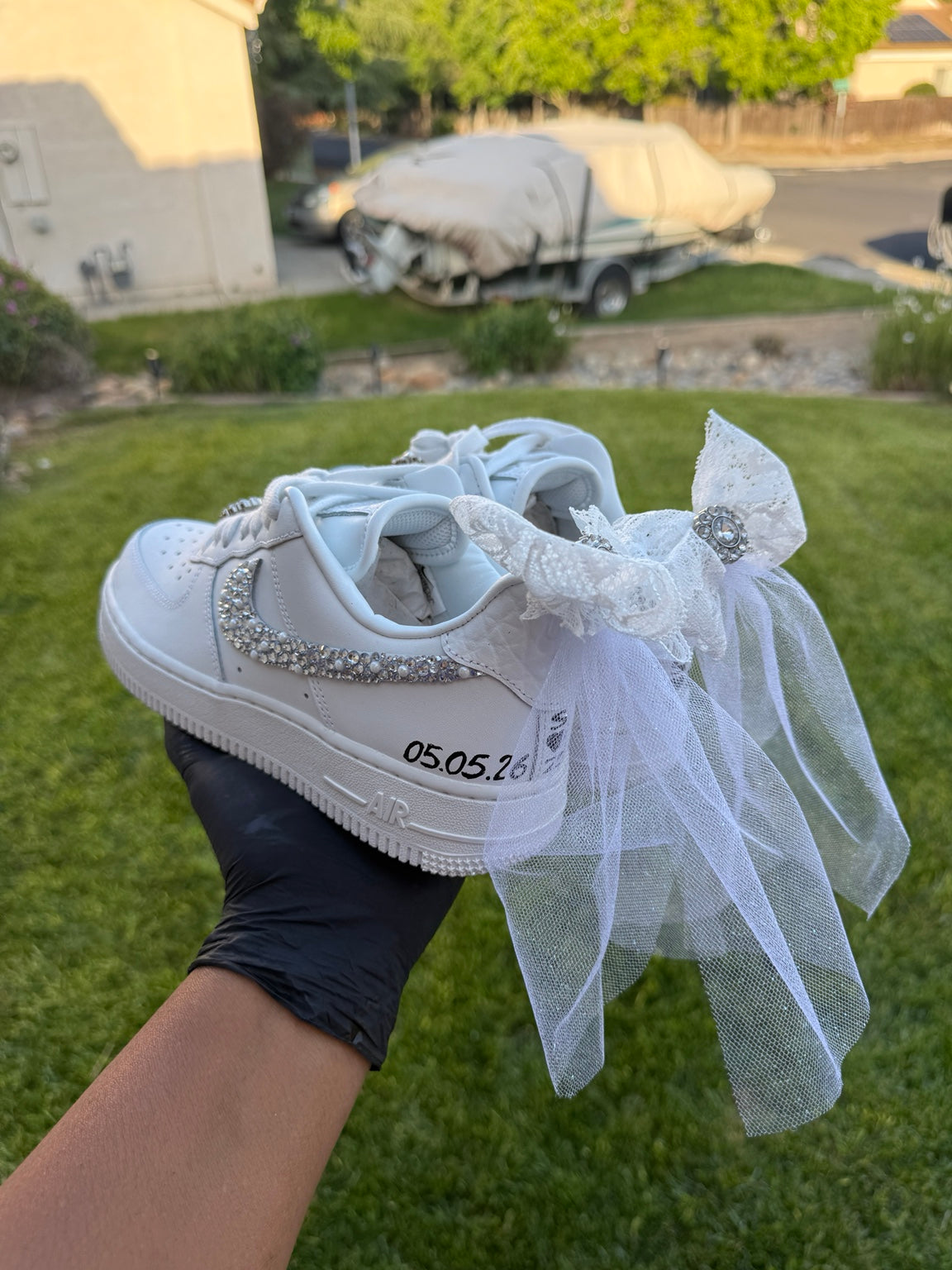 Side view of custom bridal sneakers with rhinestone swoosh and date