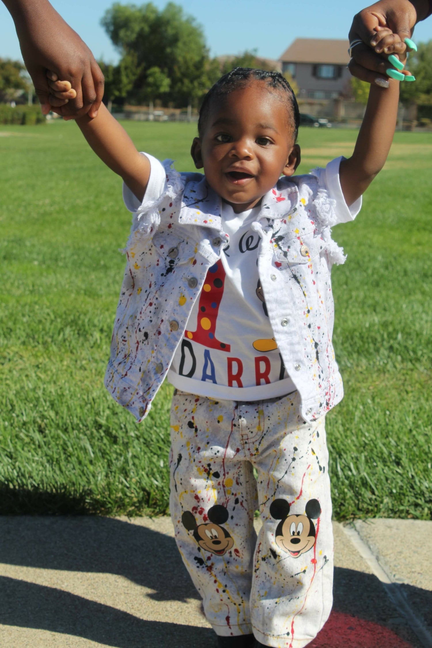 Toddler wearing a custom hand-painted denim set and personalized birthday T-shirt