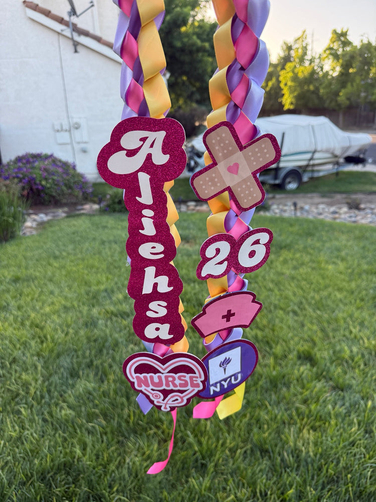 Pink and gold personalized ribbon lei for a nursing graduate